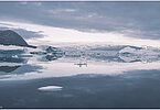 This fine-art photograph provides a beautiful view on icebergs at the Sermilik fjord in East-Greenland.