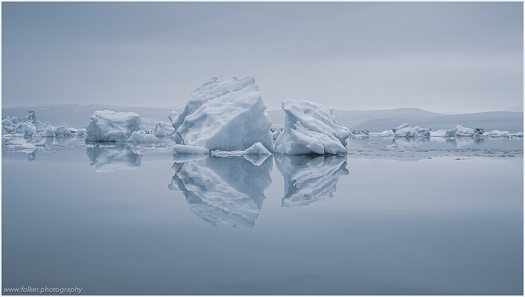 This fine-art photograph provides a beautiful view on icebergs at the Sermilik fjord in East-Greenland.