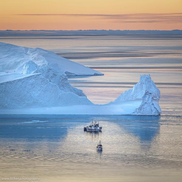 Icebergs. And fisher boats. Disko bay, Greenland