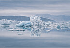 This fine-art photograph provides a beautiful view on icebergs at the Sermilik fjord in East-Greenland.