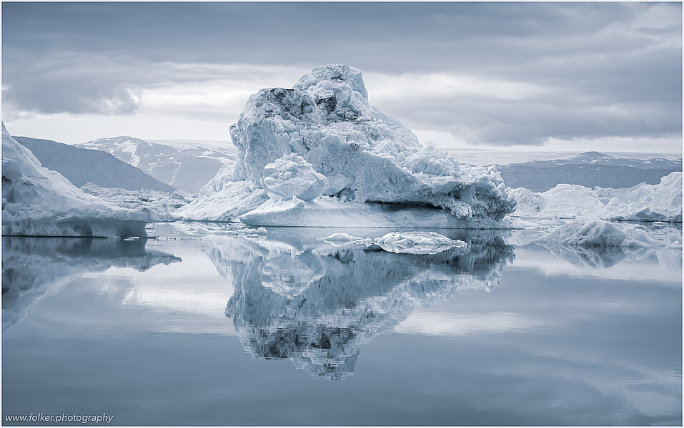 This fine-art photograph provides a beautiful view on icebergs at the Sermilik fjord in East-Greenland.